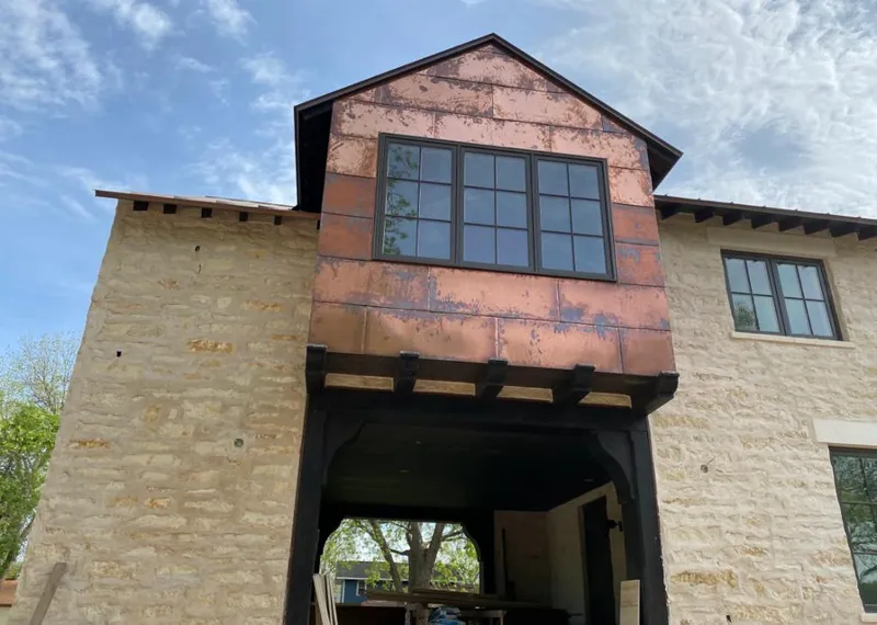 Copper metal panel facade on a stone building for Skylight Installation in Dacono
