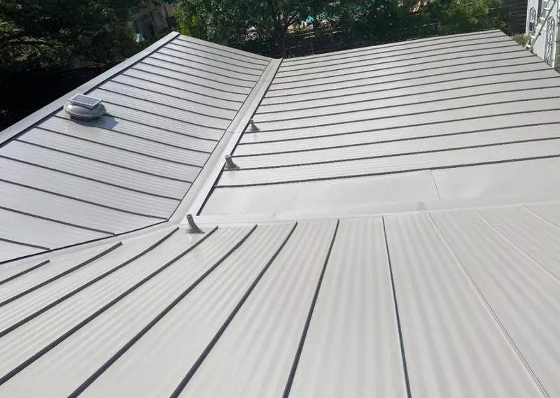 Solar attic fan installed on a metal roof for Roof Ventilation in Dacono